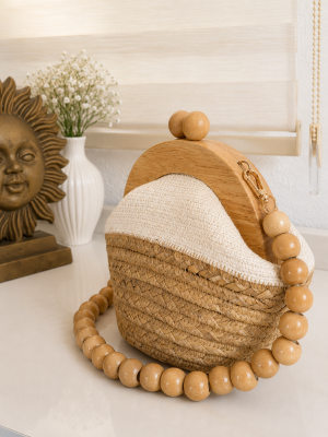 Handmade straw clutch bag with wooden frame and beaded handle in natural beige color